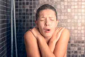 Bare Woman Reacting While Taking Cold Shower